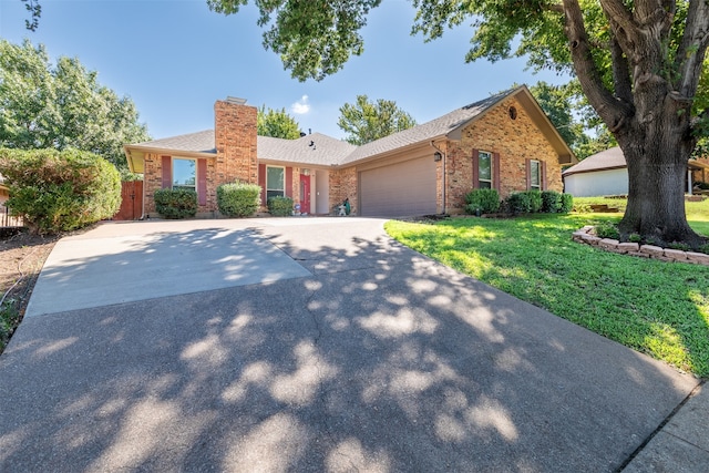 ranch-style house featuring a front yard and a garage