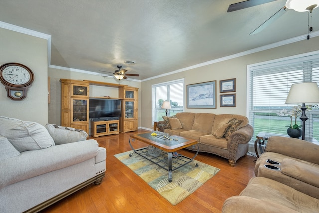 living room featuring crown molding, ceiling fan, and hardwood / wood-style flooring