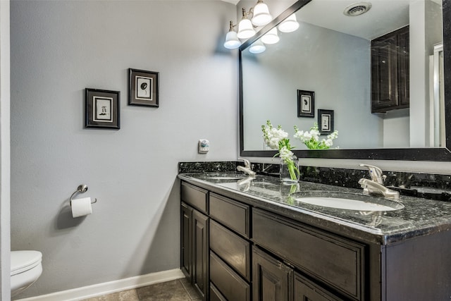 bathroom with vanity, toilet, and tile patterned floors