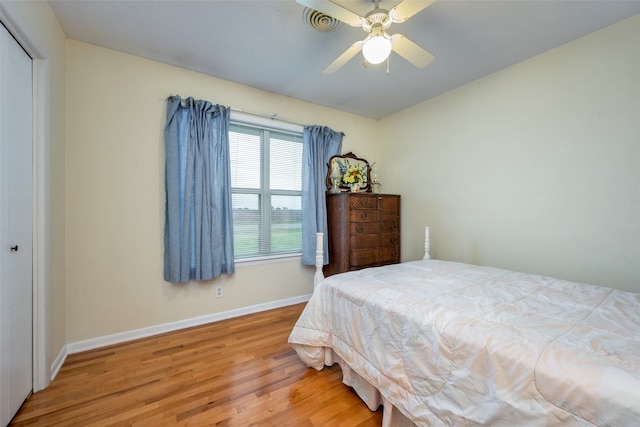 bedroom featuring hardwood / wood-style floors, ceiling fan, and a closet