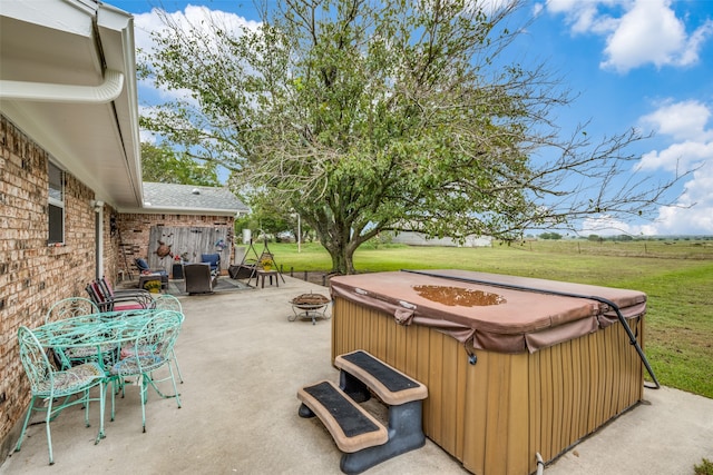 view of patio / terrace with a hot tub