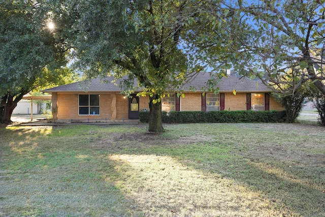 ranch-style home with a front lawn