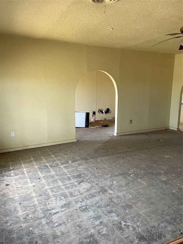 unfurnished room featuring a textured ceiling and ceiling fan