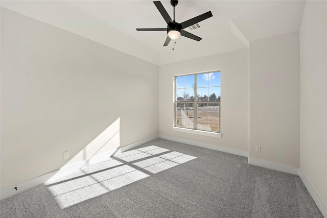 carpeted empty room featuring a ceiling fan, visible vents, and baseboards