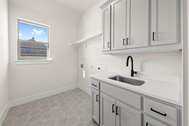 laundry area with sink, cabinets, light tile patterned floors, hookup for a washing machine, and hookup for an electric dryer