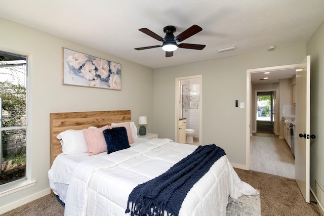 carpeted bedroom featuring ceiling fan and connected bathroom