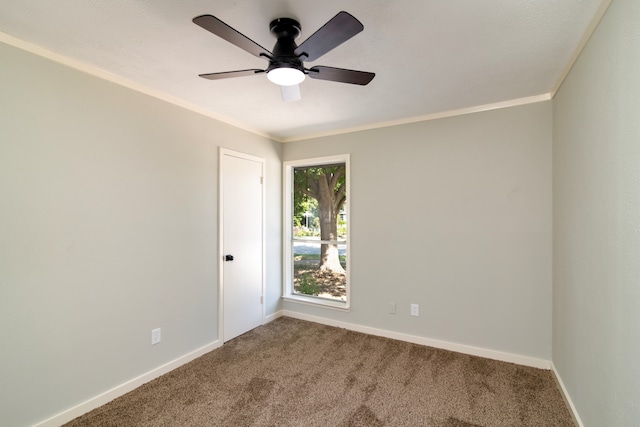 carpeted empty room featuring ceiling fan and crown molding