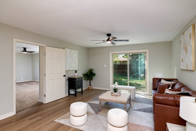 living room featuring hardwood / wood-style floors and ceiling fan