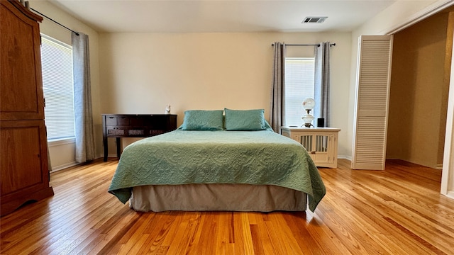 bedroom featuring light wood-type flooring and multiple windows