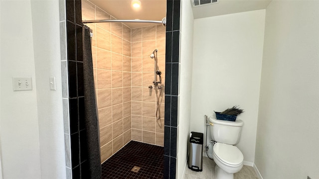 bathroom with curtained shower, tile patterned flooring, and toilet