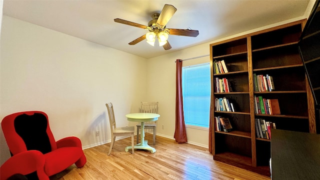 sitting room with light hardwood / wood-style floors and ceiling fan