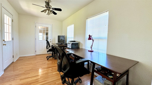 office featuring light wood-type flooring, ceiling fan, and a wealth of natural light