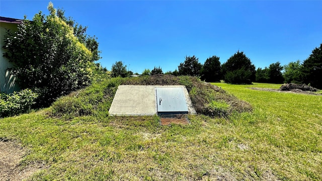 view of storm shelter featuring a yard