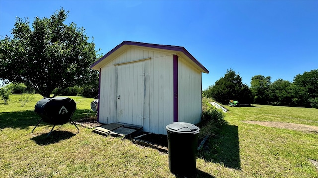 view of outbuilding featuring a yard