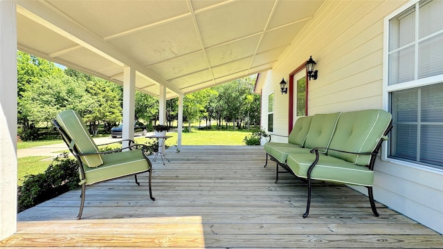 wooden terrace with an outdoor hangout area