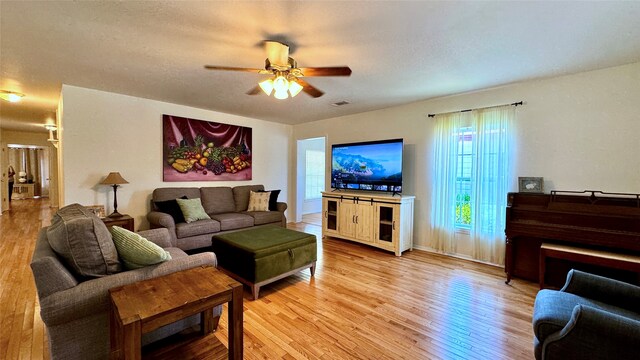 living room with ceiling fan and hardwood / wood-style flooring