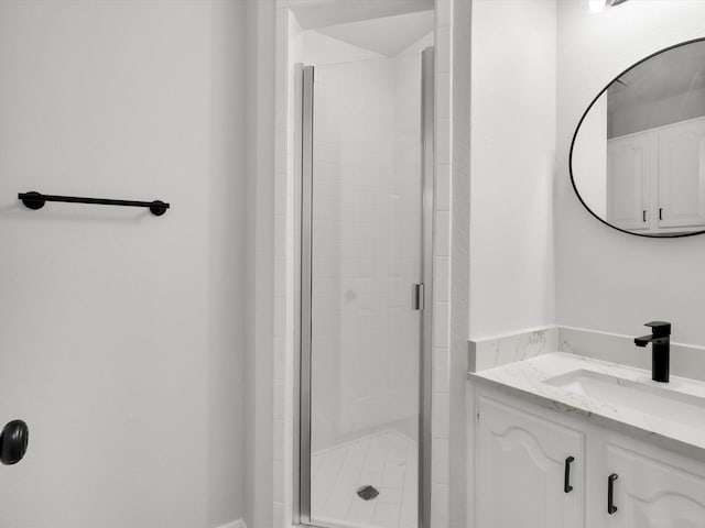 bathroom featuring vanity and a shower with shower door