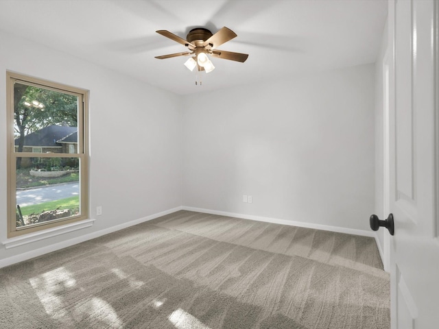 carpeted empty room featuring ceiling fan