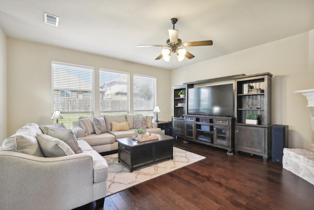 living room with ceiling fan, dark hardwood / wood-style flooring, and a fireplace