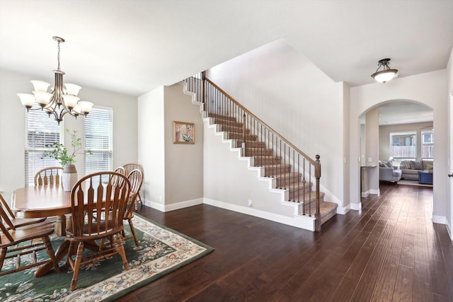 1104 Dove Haven Dr, Mansfield, TX 76063 - dining area featuring an inviting chandelier, arched walkways, hardwood / wood-style flooring, and stairway