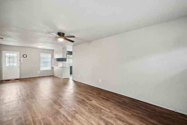 unfurnished living room with ceiling fan and wood-type flooring