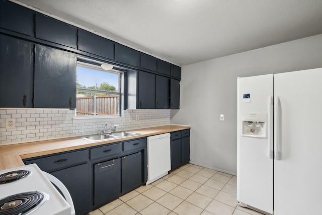 kitchen featuring decorative backsplash, white appliances, light tile patterned floors, sink, and butcher block countertops