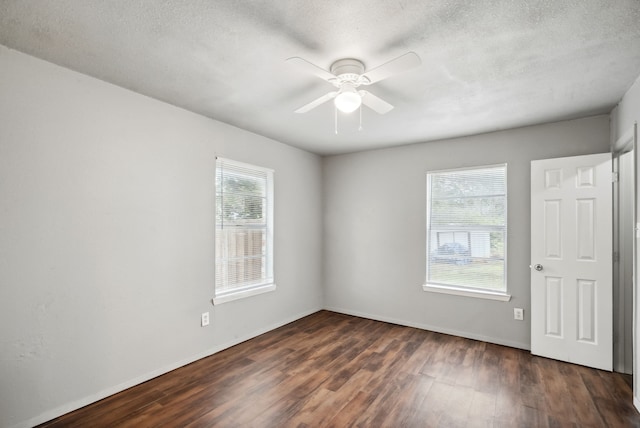 unfurnished room with dark hardwood / wood-style floors, a textured ceiling, and ceiling fan