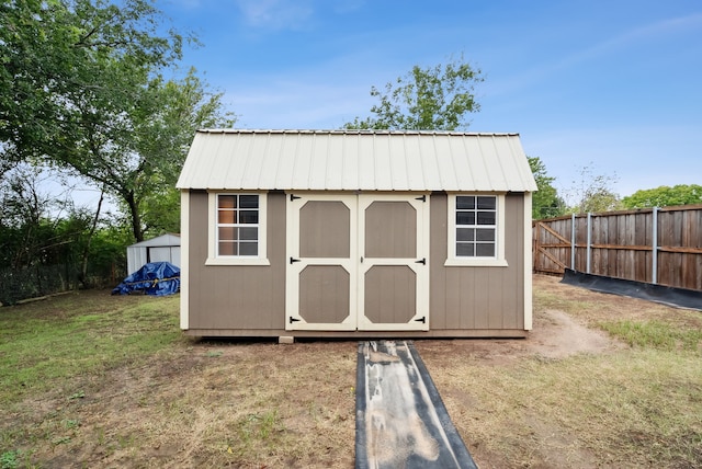 view of outbuilding featuring a lawn