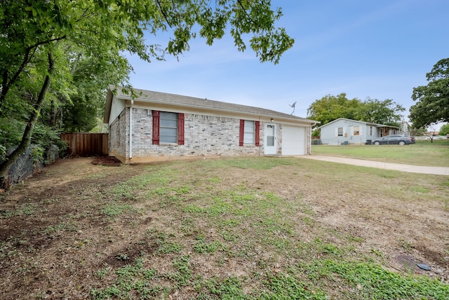 ranch-style home featuring a front lawn and a garage