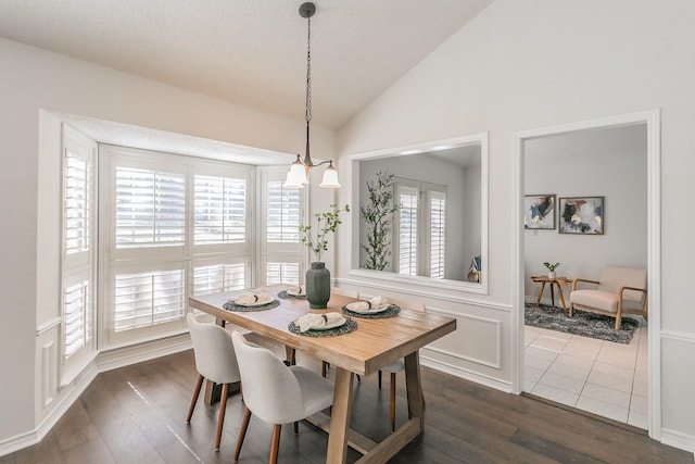 dining room with lofted ceiling and dark hardwood / wood-style flooring