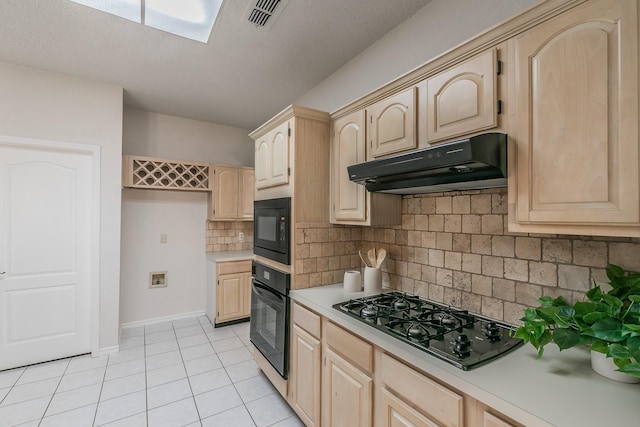 kitchen with tasteful backsplash, light tile patterned floors, light brown cabinets, and black appliances