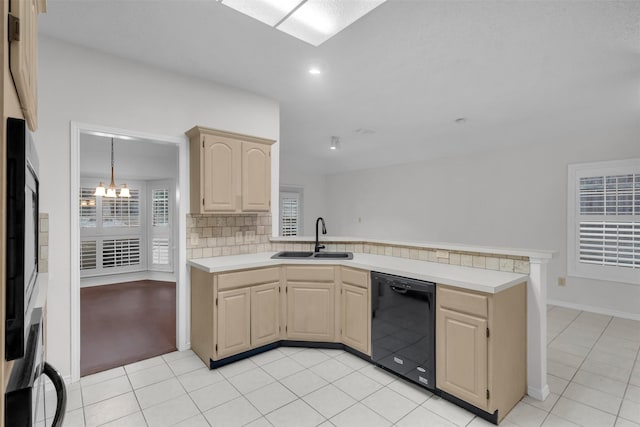 kitchen with sink, black dishwasher, a notable chandelier, light tile patterned flooring, and kitchen peninsula