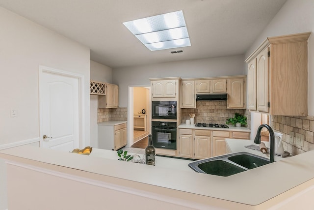 kitchen with tasteful backsplash, sink, light brown cabinetry, and black appliances