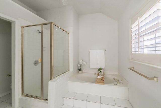 bathroom featuring tile patterned flooring, vaulted ceiling, shower with separate bathtub, and toilet