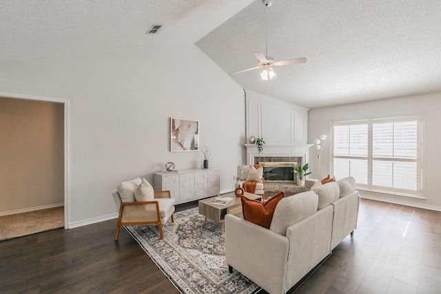 living room featuring vaulted ceiling, dark hardwood / wood-style floors, and a textured ceiling