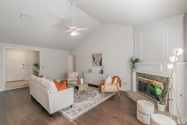 living room with a fireplace, high vaulted ceiling, dark hardwood / wood-style floors, and ceiling fan