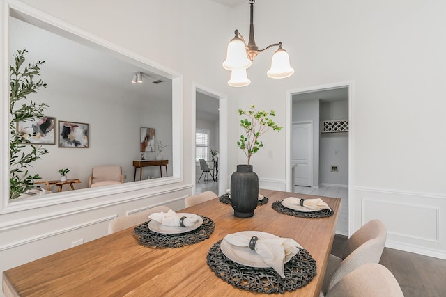 dining space featuring a notable chandelier and hardwood / wood-style flooring