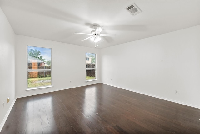 unfurnished room featuring ceiling fan and dark wood-type flooring