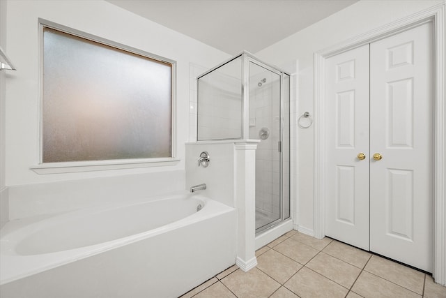 bathroom with separate shower and tub and tile patterned floors