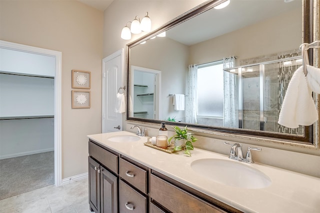 bathroom with tile patterned floors, walk in shower, and vanity