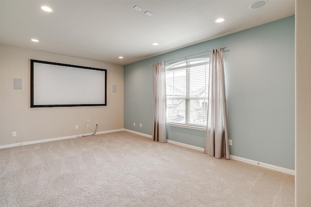 home theater with light carpet