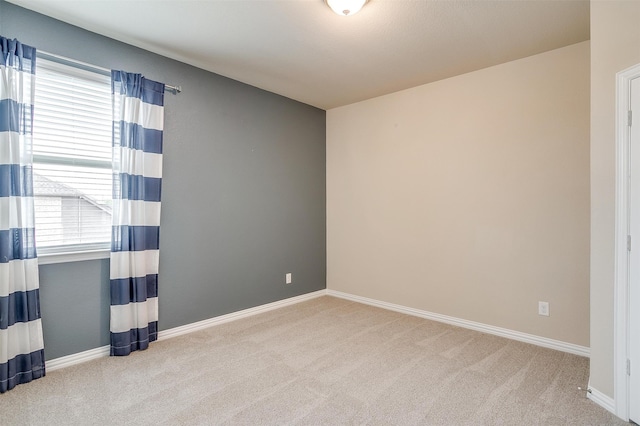 spare room with light colored carpet