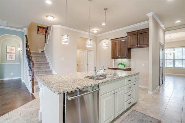 kitchen featuring ornamental molding, dishwasher, sink, and white cabinets