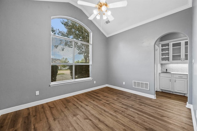 interior space featuring crown molding, vaulted ceiling, hardwood / wood-style floors, and ceiling fan