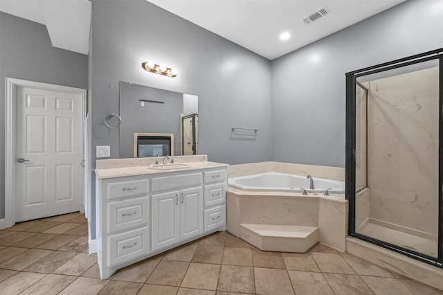 bathroom featuring plus walk in shower, tile patterned floors, and vanity