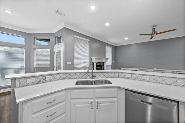 kitchen featuring ceiling fan, ornamental molding, sink, white cabinetry, and dishwasher