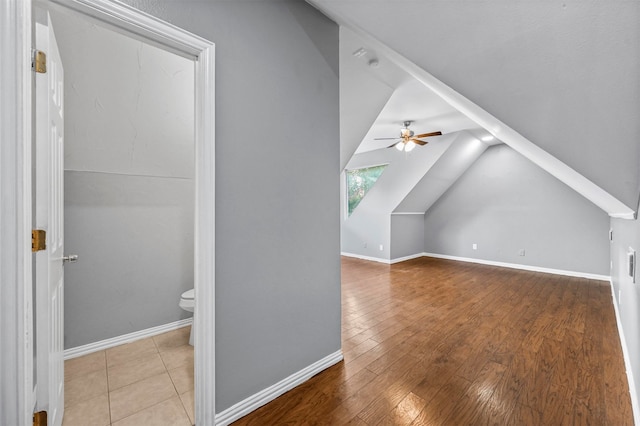 additional living space featuring light wood-type flooring, lofted ceiling, and ceiling fan