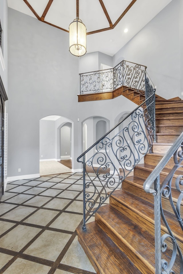 stairs featuring a high ceiling