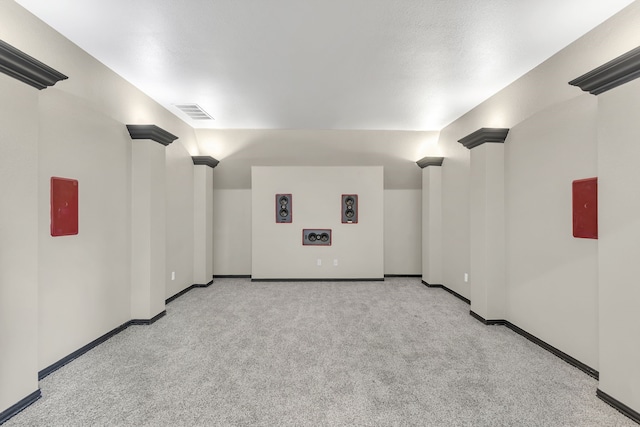 spare room with light carpet and ornate columns