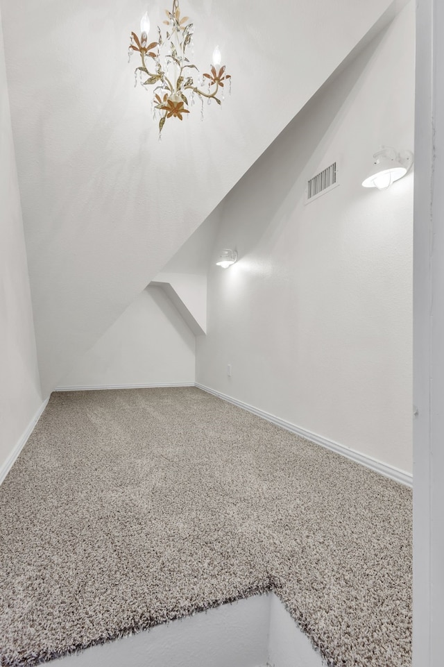 bonus room with carpet and vaulted ceiling